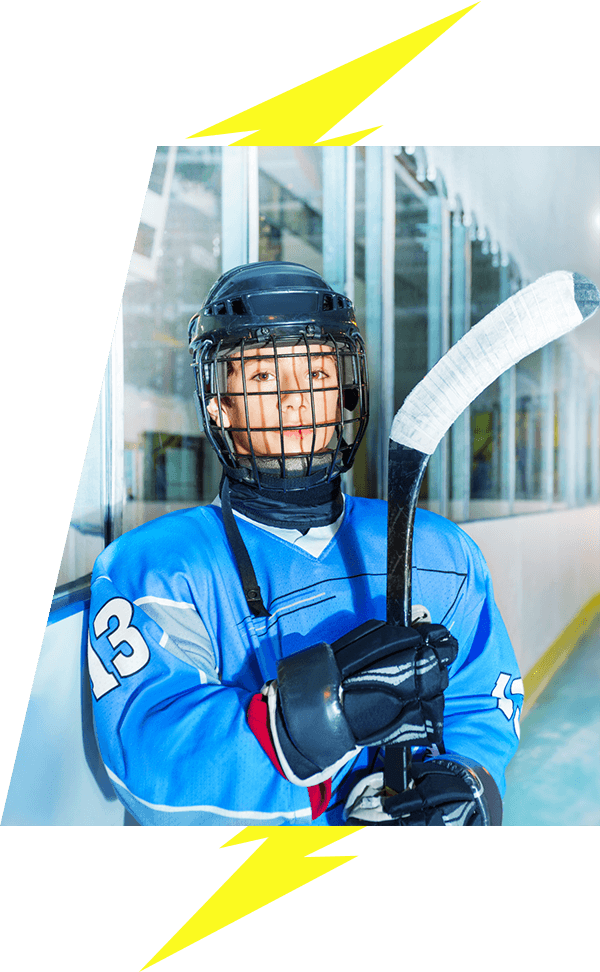 Kids hockey player with helmet and stick posing for camera lightning bolt image accents VI Storm Athletics