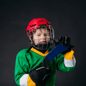 Kids hockey player posing for the camera with black background VI Storm Athletics
