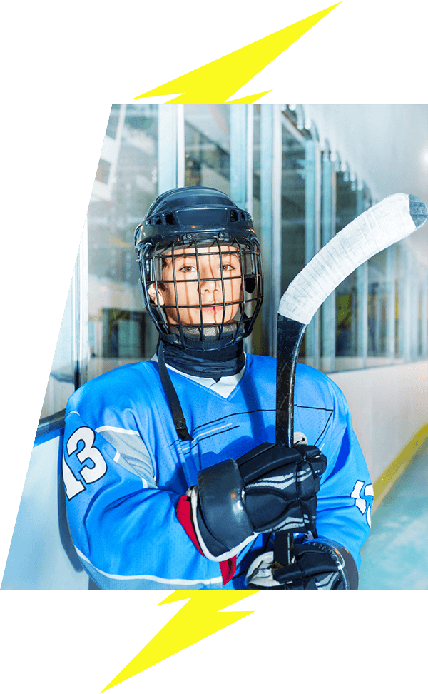 Kids hockey player with helmet and stick posing for camera lightning bolt image accents VI Storm Athletics